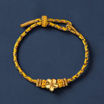 Buddha Stones Yellow Braided Rope Flower Rootedness Bracelet